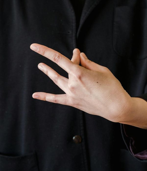 Close-up of a person's hands in a meditative mudra gesture.